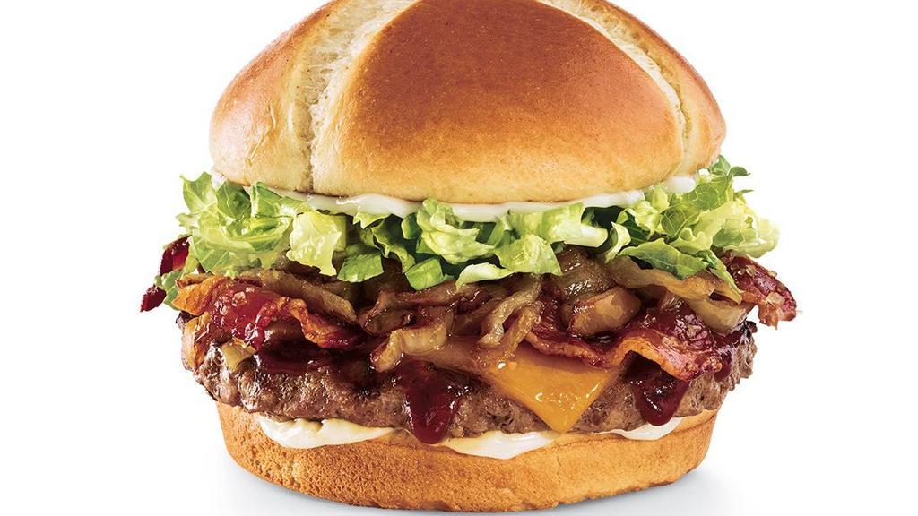 The Southern Charm Burger® · Brown sugar glaze, candied bacon, Whiskey River® BBQ Sauce, Cheddar, caramelized onions, lettuce and mayo on a toasted brioche bun.