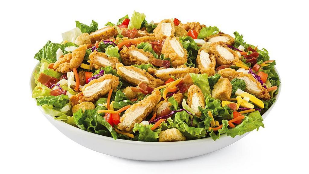 Crispy Chicken Tender · Chicken tenders, hard-boiled eggs, hardwood-smoked bacon crumbles, tomatoes, croutons and Cheddar on mixed greens. Served with choice of dressing.. Does not include calories for dressing.