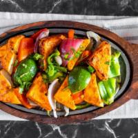 Tandoori Paneer Tikka · Marinated Indian Cottage cheese cubes, layered with Bell pepper and onions, roasted in charc...
