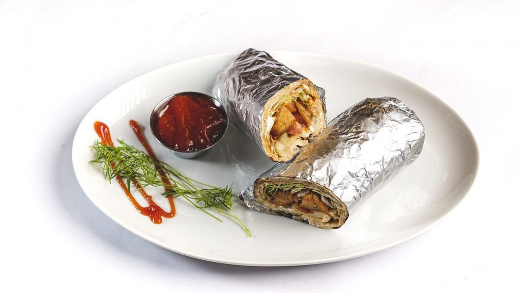 Tandoori Paneer Tikka Wrap · Clay-oven roasted Marinated Indian cottage cheese cubed with onions and bell pepper wrapped between naan bread Served With Chaas Or Soda.
