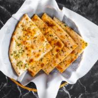Garlic Naan · White Flour Bread laced with garlic and cilantro Baked In Charcoal Fired Clay Oven