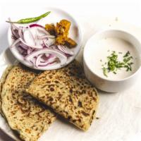 Aloo Paratha · Vegan. Pan-fried Whole Wheat Bread, Stuffed With Spiced Mashed Potatoes and cilantro.
