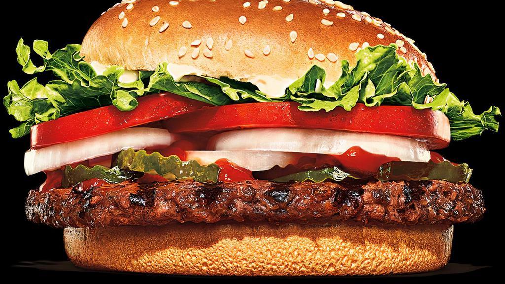 Impossible™ Whopper · Our Impossible™ Whopper Sandwich features a savory flame-grilled patty made from plants topped with juicy tomatoes, fresh lettuce, creamy mayonnaise, ketchup, crunchy pickles, and sliced white onions on a soft sesame seed bun. 100% Whopper, 0% Beef. *Cooked on the same grill as meat. Alternate cooking method available upon request.