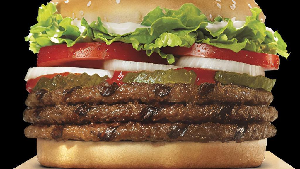 Triple Whopper · Three ¼ lb* flame-grilled beef patties with juicy tomatoes, crisp lettuce, creamy mayonnaise, ketchup, crunchy pickles, and sliced white onions on a toasted sesame seed bun. *Weight based on pre-cooked patty.
