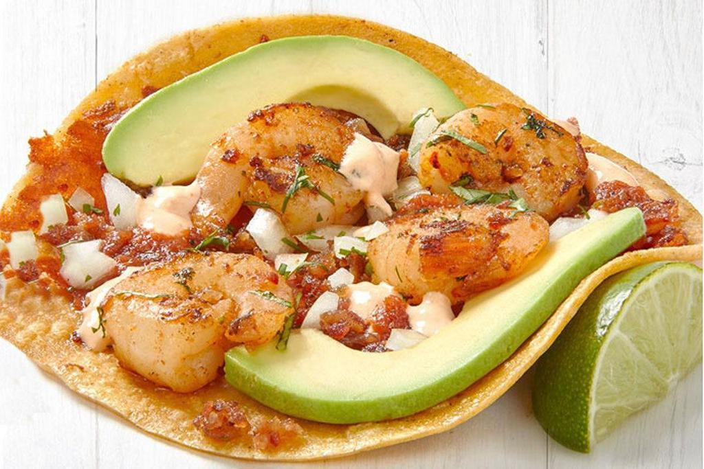 Grilled Gourmet Shrimp Taco (A La Carte) · Pan-seared shrimp served on a corn tortilla with toasted cheese, bacon, Hass avocado slices and cilantro/onion mix layered with two chile sauces.