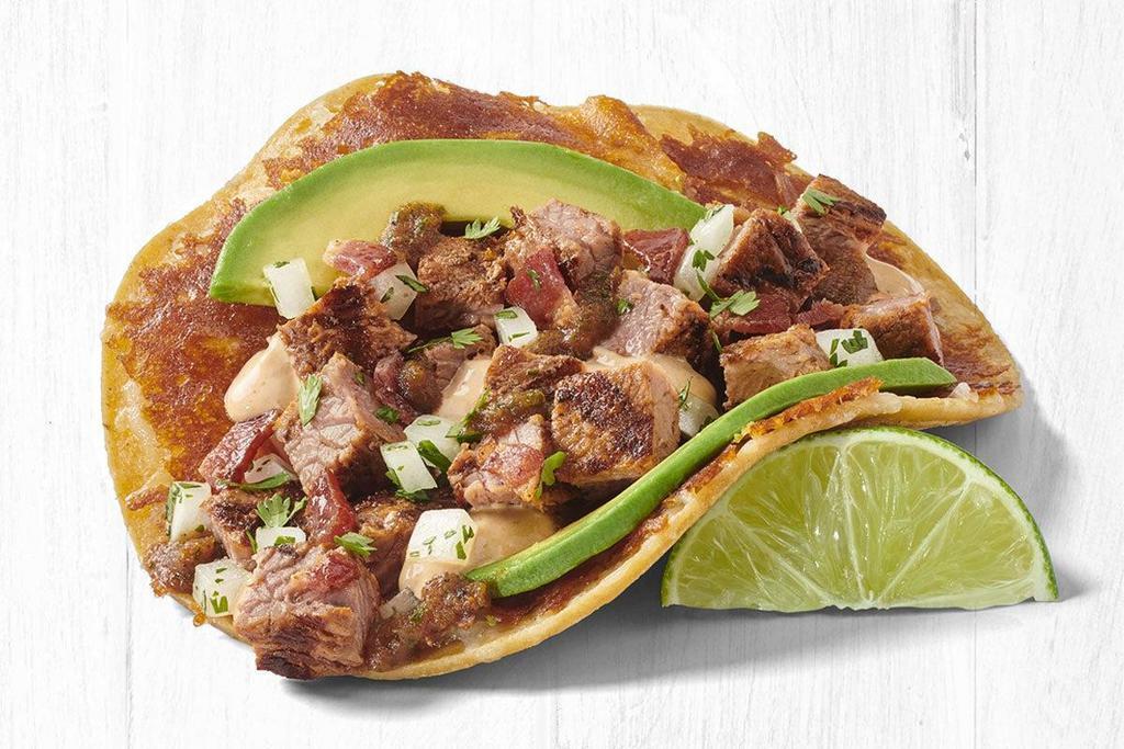 Grilled Gourmet™ Usda-Choice Steak Taco (A La Carte) · Grilled USDA-Choice Steak served on a corn tortilla   with toasted cheese, crisp bacon, Hass avocado, roasted chipotle salsa, creamy chipotle sauce and cilantro/onion mix.