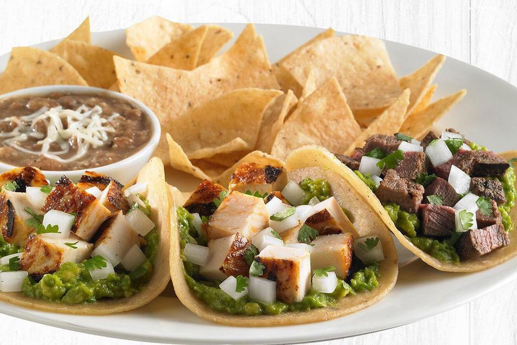 Three Street Tacos Plate · Snack-sized tacos made with choice of grilled all natural chicken, USDA-Choice steak, or Impossible meat made from plants served on corn tortillas with fresh guacamole and cilantro/onion mix.  Served with 