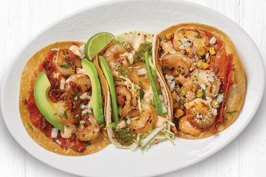 The Shrimp Trio  · Salsa Verde Shrimp Taco, Grilled Gourmet Taco™ with Shrimp, and the Wild-Caught Shrimp and Mexican Street Corn Taco.