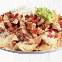 Loaded Nachos · Choice of cheese, pan-seared shrimp, all natural chicken or USDA-Choice Steak served on tort...