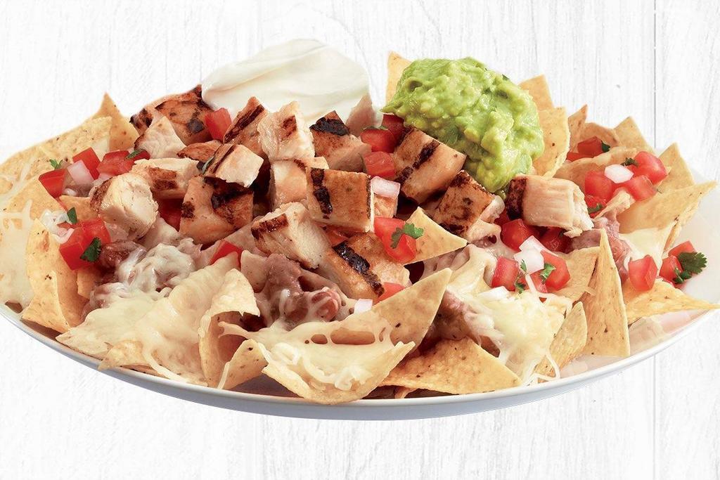 Loaded Nachos · Choice of cheese, pan-seared shrimp, all natural chicken or USDA-Choice Steak served on tortilla chips loaded with melted cheese, guacamole, salsa fresca, 