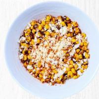 Mexican Street Corn - Large Side · Fire roasted corn topped with cotija cheese, white sauce and tajin.