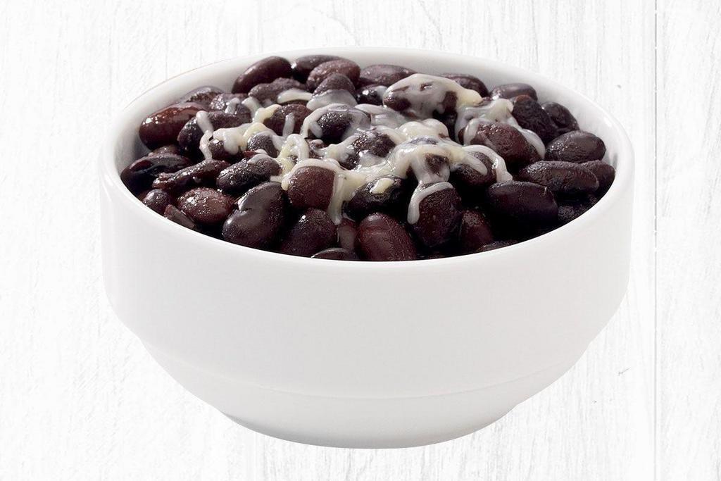 Black Beans · Made fresh daily from scratch, seasoned with a dash of garlic and topped with shredded cheese.