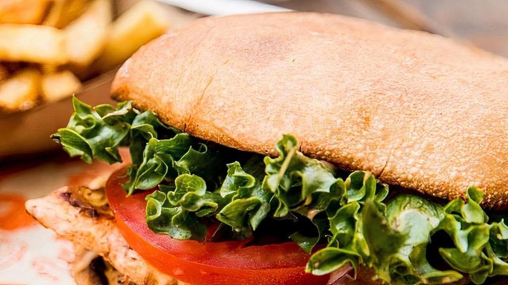 CHICKEN SANDWICH · All natural free range grilled chicken breast, served with lettuce, tomato, red onion, and house-made chipotle aioli on a fresh baked ciabatta bun.