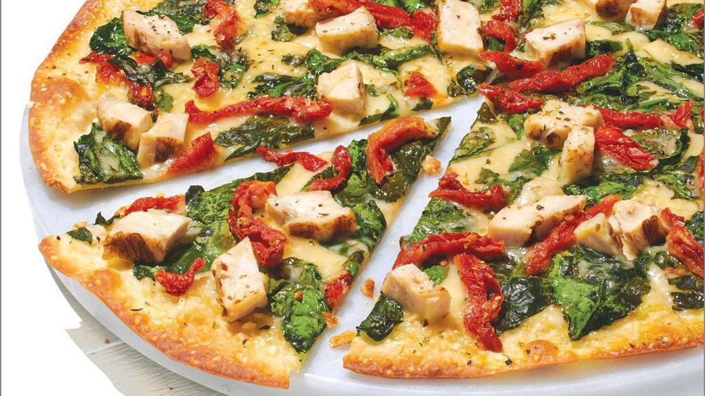 Dairy Free Cheese Herb Chicken Mediterranean - Baking Required · Our Artisan Thin Crust, topped with Olive Oil, Chopped Garlic, Dairy Free Mozzarella, Grilled Chicken Raised Without Antibiotics, Fresh Spinach, Sun-dried Tomatoes, Zesty Herbs