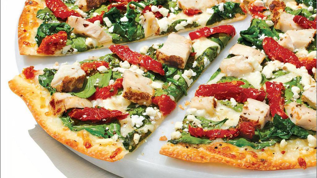 Herb Chicken Mediterranean - Baking Required · Our Artisan Thin Crust, topped with Olive Oil, Chopped Garlic, Whole-Milk Mozzarella, Grilled Chicken Raised Without Antibiotics, Fresh Spinach, Sun-dried Tomatoes, Crumbled Feta and Zesty Herbs