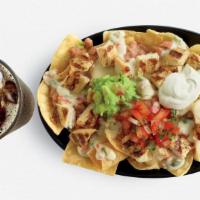 Chicken Nachos · We start with our crisp tortilla chips and top with pinto beans, fire-grilled chicken, queso...