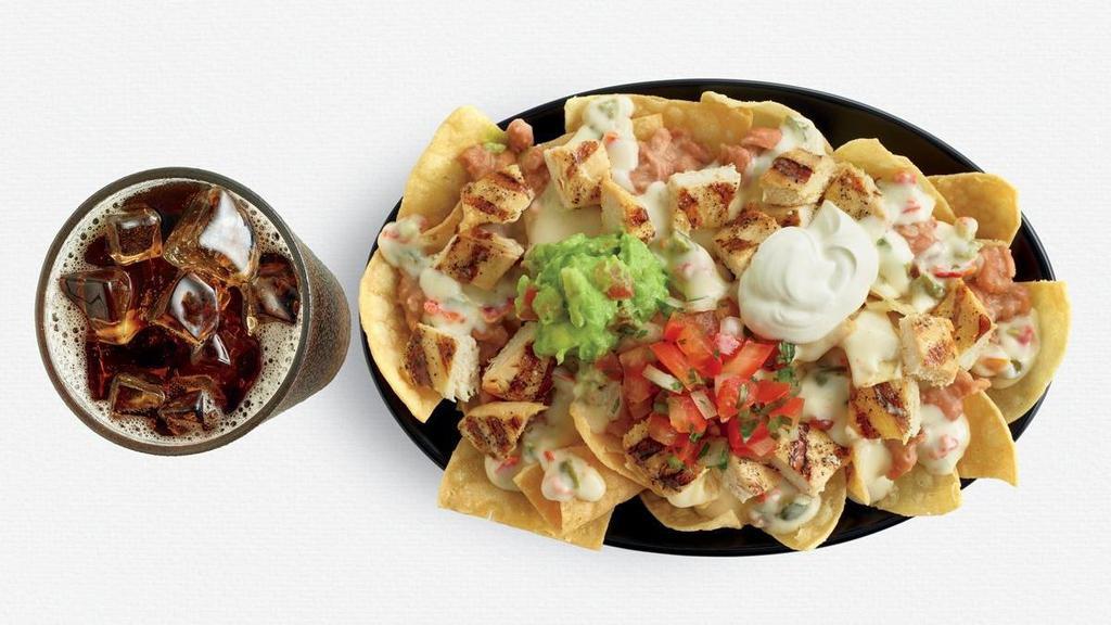 Chicken Nachos · We start with our crisp tortilla chips and top with pinto beans, fire-grilled chicken, queso sauce, pico de gallo salsa, guacamole and sour cream. Combo includes regular drink.