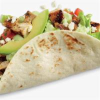 Chicken Avocado Taco · Fire-grilled chicken, avocado, shredded lettuce, jack cheese, and pico on a handcrafted tort...