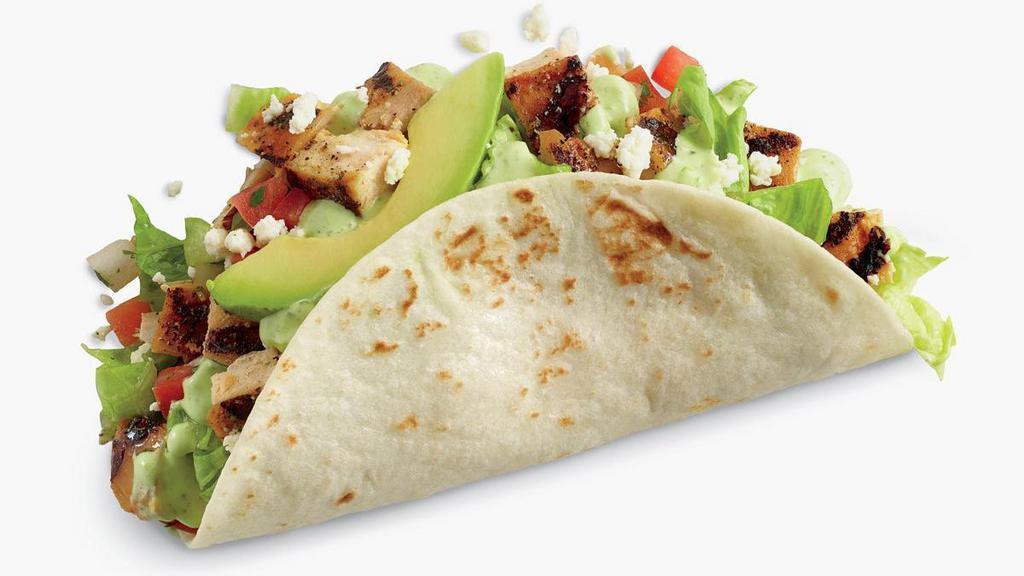 Chicken Avocado Taco · Fire-grilled chicken, avocado, shredded lettuce, jack cheese, and pico on a handcrafted tortilla and finished with creamy cilantro dressing.