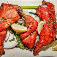 Tandoori Chicken · Chicken leg quarters marinated in yogurt and a blend of spices then cooked in a clay oven.