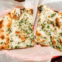 Garlic Naan · White flour bread garnished with freshly chopped garlic and cilantro baked in tandoor.