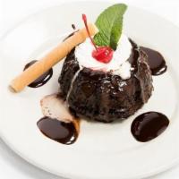 MOLTEN CHOCOLATE CAKE · Dark chocolate cake, warm fudge center, topped with whipped cream