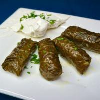 Dolmades · Four large grape leaves stuffed with rice, mushrooms and fresh herbs; made fresh in-house an...