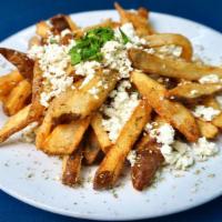 Ikaros Fries · Fresh hand cut potatoes pan fried in blended olive oil and topped with Greek feta, and orega...