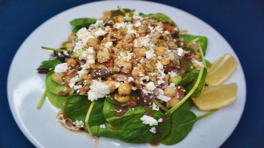 Mediterranean Salata · Fresh spinach, diced tomatoes and cucumbers, artichoke hearts, sliced Kalamata olives, garbanzo beans, crumbled feta, red onions and candied walnuts; served with balsamic vinaigrette.