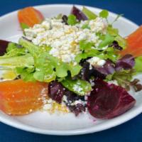 Pantzarosalata (Beet Salad with Feta) · Traditional Greek Beet Salad mixed golden and red beets over a bed of salad greens topped wi...