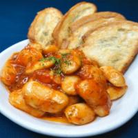 Gigantes · Baked large Greek white beans served chilled in red sauce with dill and olive oil; served wi...