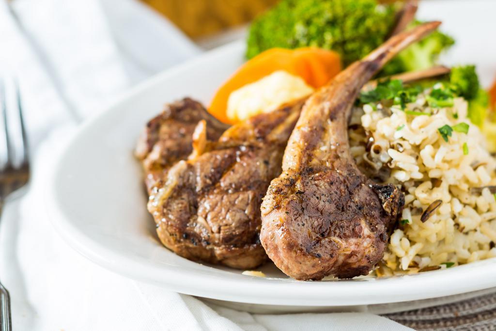 Lamb Chops · Two double cut lamb chops char-broiled over an open flame seasoned with fresh herbs and lemon; served with vegetables and choice of oven potatoes, steak fries or rice pilaf.