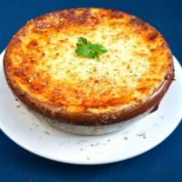 Traditional Moussaka · Layers of eggplant, potatoes and red meat sauce topped with a rich, creamy béchamel.