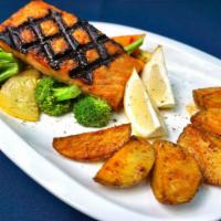 Fresh Salmon · Grilled over an open flame, lightly seasoned and topped with a special whipped lemon and oli...