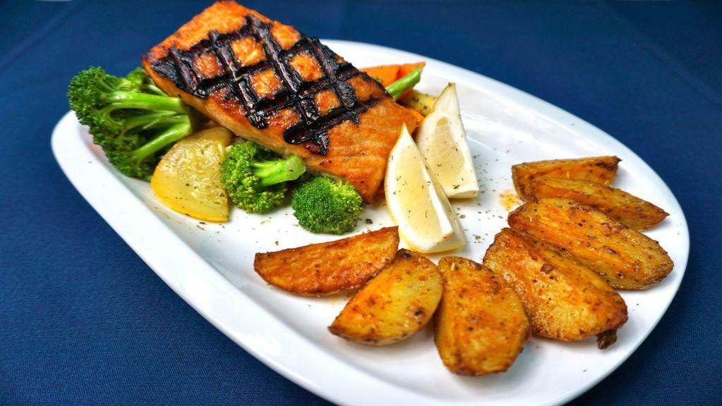 Fresh Salmon · Grilled over an open flame, lightly seasoned and topped with a special whipped lemon and olive oil sauce; served with vegetables and choice of oven potatoes, steak fries or rice pilaf.