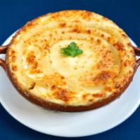 Pastisio · Layers of Greek macaroni and meat sauce topped with rich, creamy béchamel.