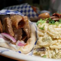 Ikaros Gyro Sandwich · A traditional blend of marinated lamb & beef gyro meat served on pita with tomatoes, red oni...
