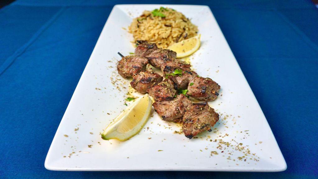 Lamb Souvlaki · Tender skewers of lamb, marinated with fresh herbs and cooked over an open flame.