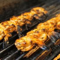 Shrimp Souvlaki · Skewers of shrimp, marinated with fresh herbs and lemon and cooked over an open flame.