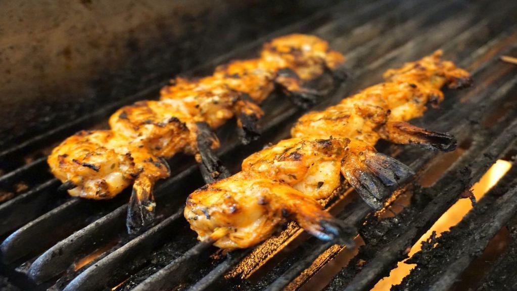 Shrimp Souvlaki · Skewers of shrimp, marinated with fresh herbs and lemon and cooked over an open flame.