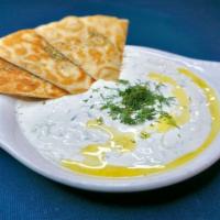 Tzatziki · The famous Greek yogurt, cucumber, dill & garlic dip. Served with one pita bread.