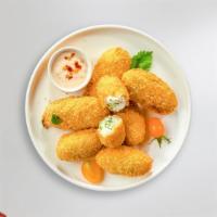 Papa Peno Popper · Fresh jalapenos coated in cream cheese and fried until golden brown.