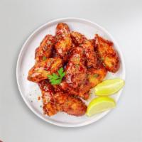 Honey Johnny Wings · Fresh chicken wings breaded, fried until golden brown, and tossed in honey. Served with a si...