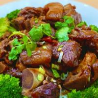 C16. Braised Pork Feet 紅燒猪腳 · Meaty Pork Hog stewed with soy sauce flavored sauce served with broccoli