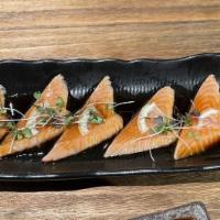 Sear Salmon Belly · 6 pieces sear salmon belly topped with lemon slice shichimi pepper and tobiko served with se...