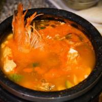 Soon Doo Boo · Silky organic tofu stew in spicy broth with red chili pepper served with different kinds of ...