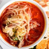 Yuk Gae Jang · Spicy beef stew with glass noodles, scallions, egg drop served with different kinds of seaso...