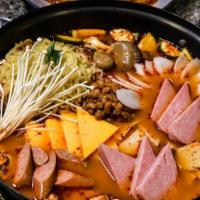 Bu Dae Jigae(Army Stew) · Homemade mild spicy beef soup with sausage, spam, homemade ricecake,kimchi, beans, cheese, a...