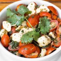 Caprese Salad · Tomatoes, fresh mozzarella, basil, and chimichurri dressing.