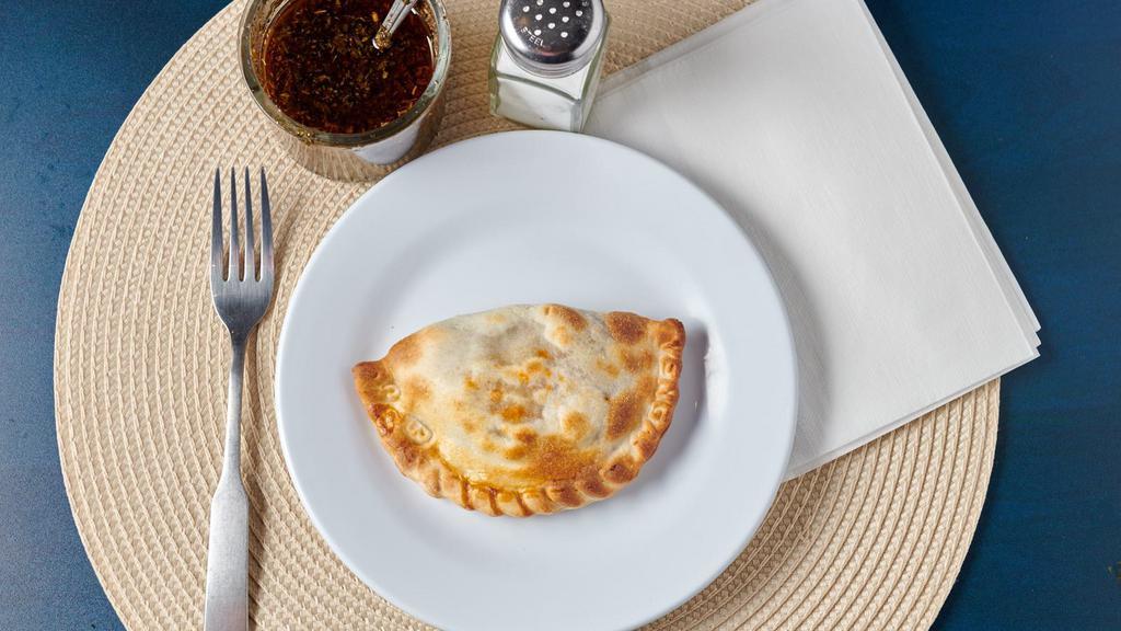 Argentine Beef Empanada · Natural ground beef, onions, red bell pepper, and hardboiled egg.